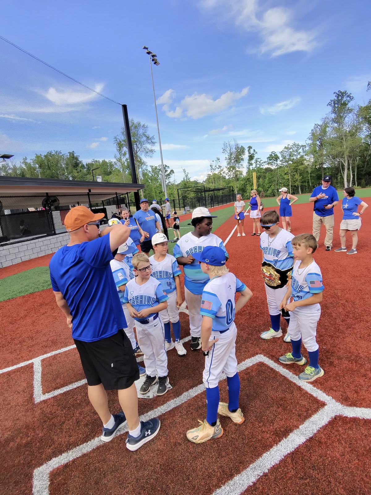 Beehive Stars players and coaches gathered beside the field