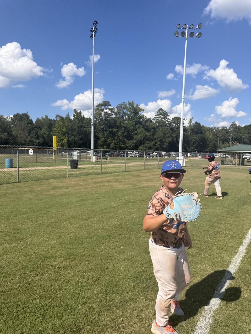 11U National player warming up in the outfield before a game