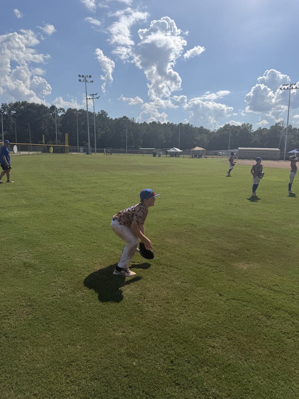 11U National fielder working on ground balls before the game